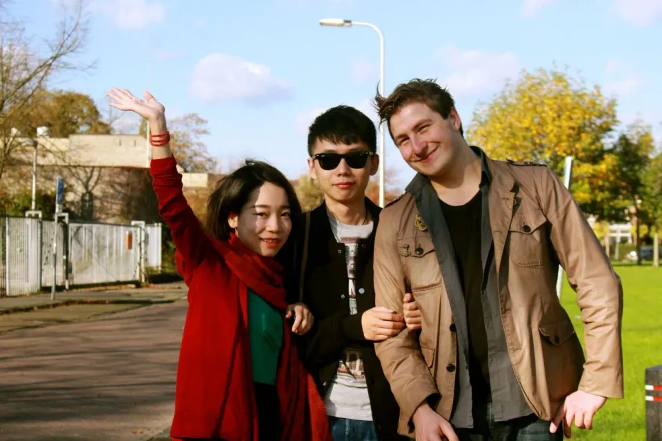 An early photograph of Ricky and Kees with a friend outdoors.