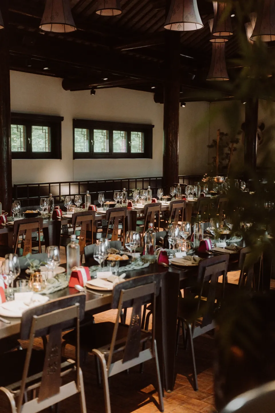 The dinner setting at Pandasia, with long laid tables and wooden chairs.