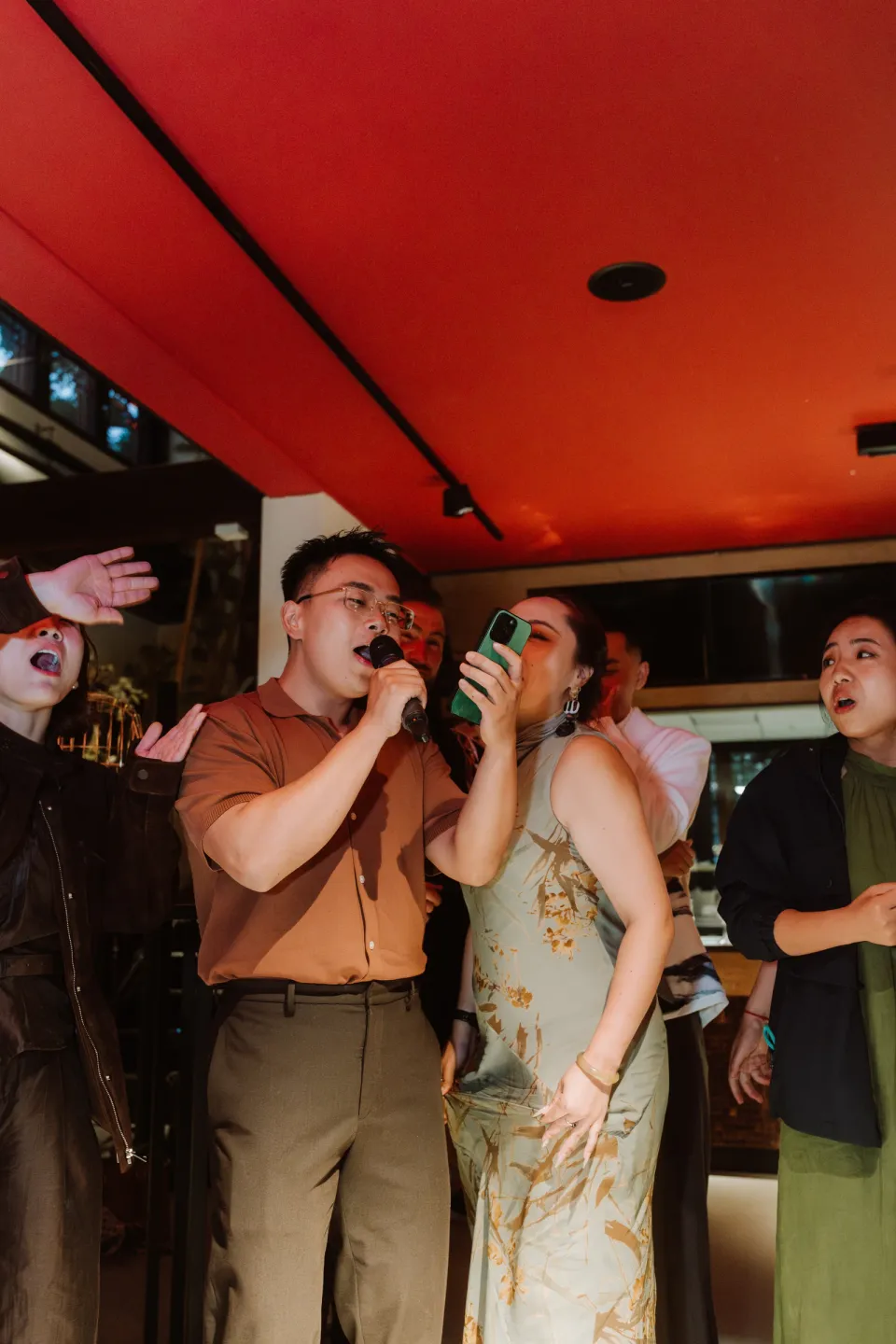 Andy singing into a microphone among the wedding guests.