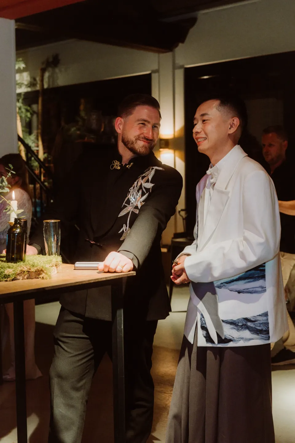 Kees and Ricky smiling together at the party.