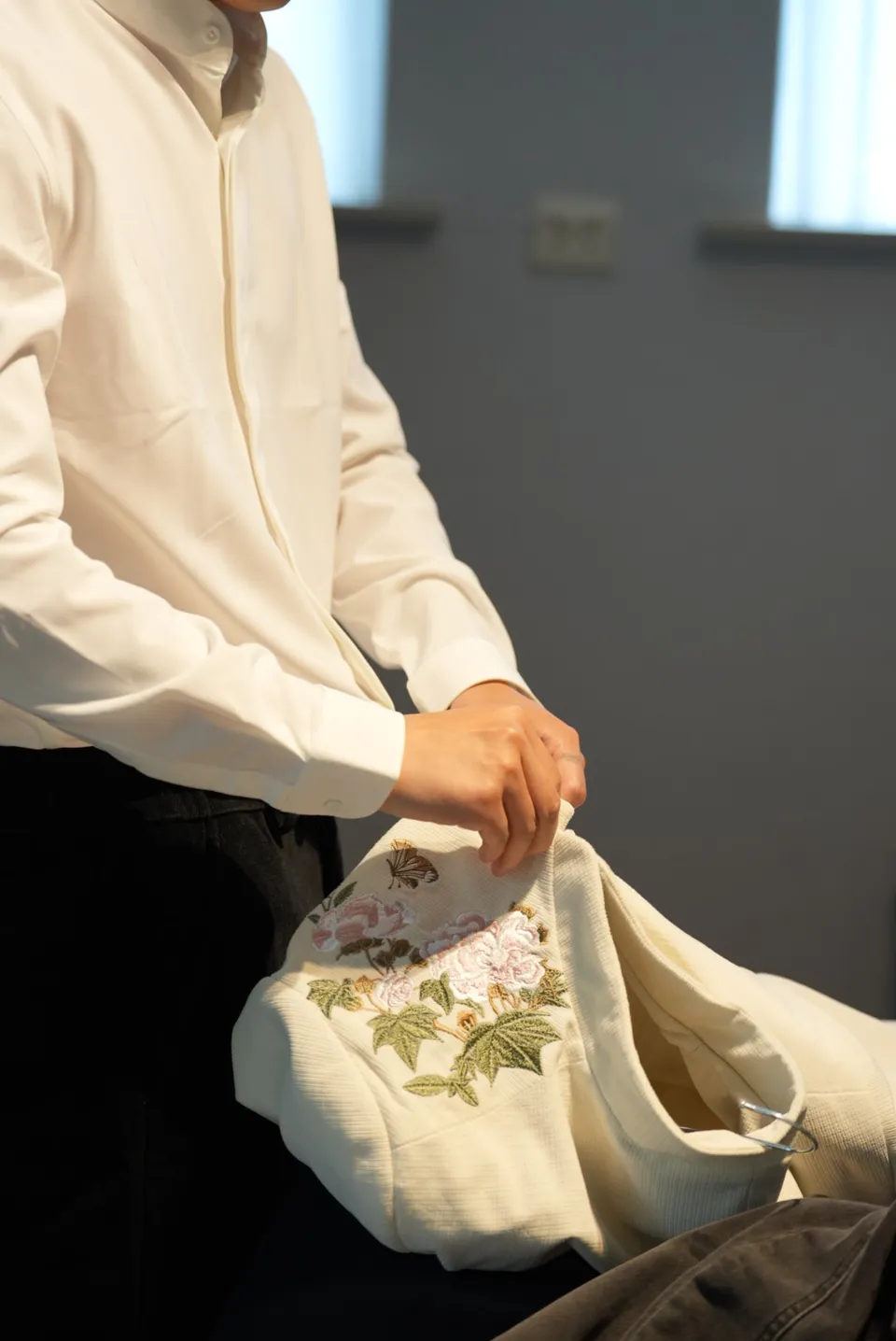 Ivory clothing and floral embroidery being prepared at the hotel.