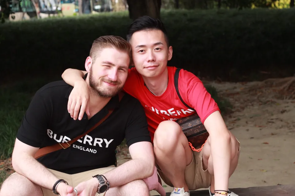 Kees and Ricky sitting close together outdoors in their relationship archive.